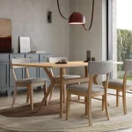 CHAIR: Bella, Maple Wood, 2402 Reign Fabric & 100 Natural Stain TABLE: Oslo Table, Rounded Edge, Maple Wood & 100 Natural Stain CASE: Cosmo Server (2), Maple Wood, 34P Foxhall Green Paint & Custom Hardware TK901HB (Doors) and TK942HB (Drawers) image of MV_DiningRoom_Oslo_view01-2